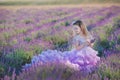 Girl in a straw hat in a field of lavender with a basket of lavender. A girl in a lavender field. Girl with a bouquet of lavender.