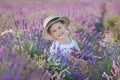 Girl in a straw hat in a field of lavender with a basket of lavender. A girl in a lavender field. Girl with a bouquet of lavender.