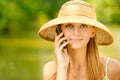 Girl in straw hat with phone Royalty Free Stock Photo