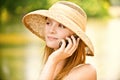 Girl in straw hat with phone Royalty Free Stock Photo