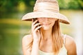 Girl in straw hat with phone Royalty Free Stock Photo