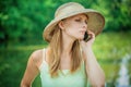 Girl in straw hat with phone Royalty Free Stock Photo