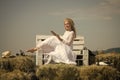 Girl in straw wreath and white dress on sunny day Royalty Free Stock Photo