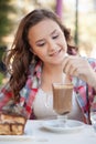 Girl in the street drink a capuccino Royalty Free Stock Photo