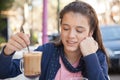 Girl in the street drink a capuccino Royalty Free Stock Photo