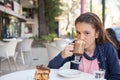 Girl in the street drink a capuccino Royalty Free Stock Photo