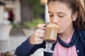 Girl in the street drink a capuccino Royalty Free Stock Photo