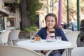 Girl in the street drink a capuccino Royalty Free Stock Photo