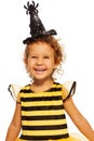 Girl in striped bee costume wearing spider hat Royalty Free Stock Photo