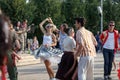 Moscow, Russia, September 08, 2018: girl in striped lush skirt dancing rock and roll on the dance floor with a man in Gorky Park