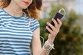 Girl in striped t-shirt is listening to music