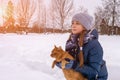 A girl strokes a red cat. Love for animals. Artistically colored photography