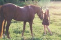 Girl stroking her horse