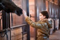 Girl stroking horse