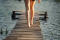 Girl strolling along a pier on pond on sunset