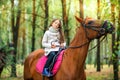 A girl strolls on her horse