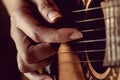 Girl strumming the strings of a guitar.