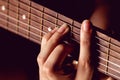 Girl strumming the strings of a guitar. Royalty Free Stock Photo