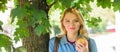 Girl student with backpack hold apple while stand near tree. Students life concept. Take minute to relax. Break for