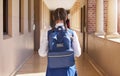 Girl student, backpack and walking in a school back for study, education and morning class. Young students back view Royalty Free Stock Photo