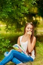 Girl student with books eating an apple Royalty Free Stock Photo