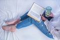 Cozy Study Time: Young Woman Immersed in Learning and Relaxation