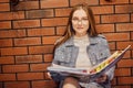 Girl student sit in the corridor of the university / university dormitory and teaches homework, lectures. The girl in glasses