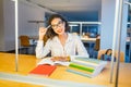 Girl student with stylish glasses reading books in the library Royalty Free Stock Photo