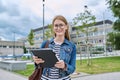 Girl student teenager outdoor near school building