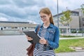 Girl student teenager outdoor near school building