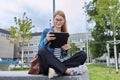 Girl student teenager outdoor near school building