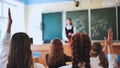 Girl students raise their hands in math class. Royalty Free Stock Photo