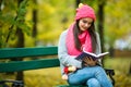 Girl students read book in yellow autumn park