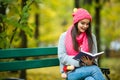 girl students read book in yellow autumn park