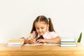 Girl studing at table on white background