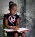 Girl in studio reading a book