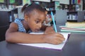 Girl studying at desk in library