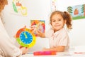 Girl studying hours and minutes at the clock