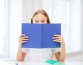 Girl studying and reading book at school Royalty Free Stock Photo