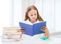 Girl studying and reading book at school Royalty Free Stock Photo