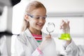 Girl studying test tube at school laboratory