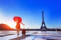 Girl with stylish red clothes, umbrella, suitcase, Eiffel Tower, fashion Royalty Free Stock Photo