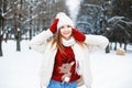 Girl in stylish winter clothes resting in a park on a background Royalty Free Stock Photo