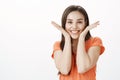 Girl suggest smile more. Portrait of joyful carefree adorable adult woman in orange sweater, smiling broadly and holding