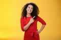 Girl suggesting try out new product. Friendly and pleasant happy young european brunette with curly hair tilting head Royalty Free Stock Photo