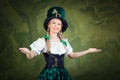 The girl in the suit of St. Patrick is welcome on a green backgr Royalty Free Stock Photo