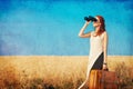 Girl with suitcase and binocular at countryside road Royalty Free Stock Photo