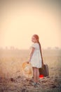 Girl with suitcase and hat Royalty Free Stock Photo