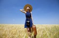 Girl with suitcase at spring wheat field. Royalty Free Stock Photo