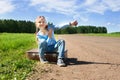 Girl with suitcase standing about road Royalty Free Stock Photo